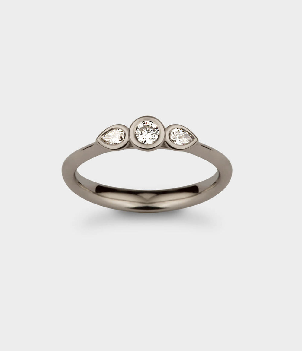 top view of a delicate three stone angel engagement ring in white gold with diamonds