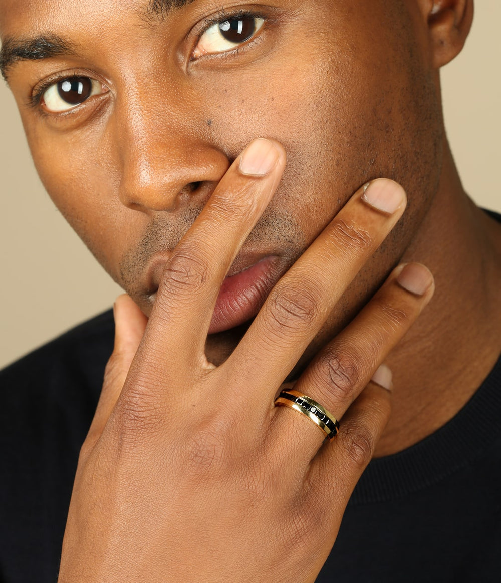 a mans hand wearing a platinum geo eternity ring. we see his face